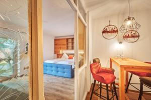 a room with a bed and a table with a chair at Landhotel Sportalm in Philippsreut