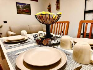 a dining room table with plates and a lamp on it at Casa Armida in Tirano +11 photos