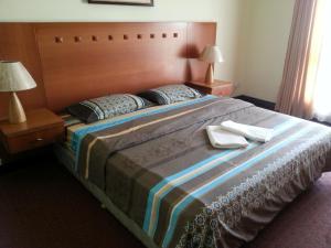 a bedroom with a large bed with two towels on it at T & H Vacation Condo @Marina Court in Kota Kinabalu +44 photos