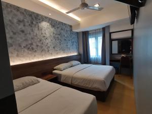 Voodi või voodid majutusasutuse Lumut Hotel toas