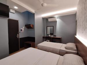 Voodi või voodid majutusasutuse Lumut Hotel toas