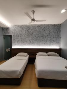 Voodi või voodid majutusasutuse Lumut Hotel toas