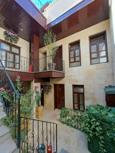 a building with two balconies and a courtyard with plants at Levissi boutique hotel in Gaziantep