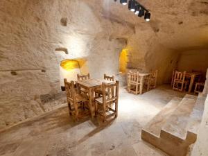 a room with a table and chairs in a stone building at Levissi boutique hotel in Gaziantep