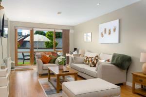 a living room with two couches and a table at Apartment 453 - Clifden in Clifden