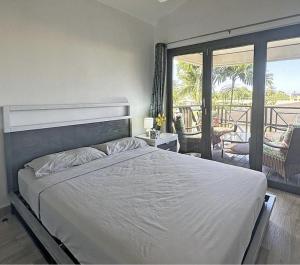 a bedroom with a large bed and a balcony at Ixora in Saint James +51 photos