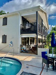 a house with a swimming pool in front of a house at Ixora in Saint James