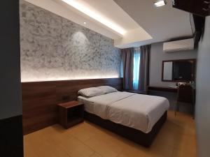 Voodi või voodid majutusasutuse Lumut Hotel toas