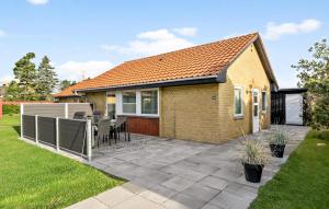 a house with a patio in the yard at Holiday Home Nørre Nebel 58 in Nymindegab +14 photos