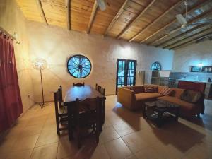 a living room with a couch and a table at Casa de campo parque Iberá in Colonia Carlos Pellegrini