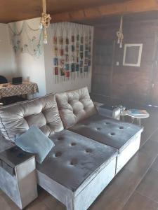 a living room with a couch and a table at Casa BuLuMAR in Conventos