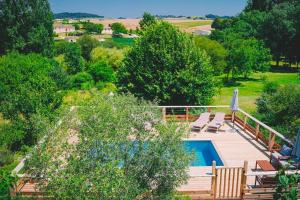 an overhead view of a deck with a swimming pool at Gite Chez Grigri pour max 11 pers avec piscine chauffée et jardin in Villebois-Lavalette