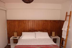 a bedroom with a bed with two night stands at Hotel Velero Sur in Iquique