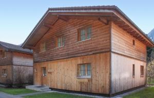 a wooden house with a gambrel roof at Tolles Feriehaus Montafon in Bartholomäberg
