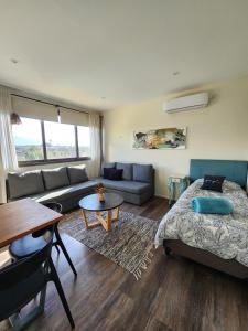 a living room with a bed and a couch at Olivos de Terrada in Ciudad Lujan de Cuyo +26 photos