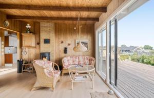 a living room with a table and chairs on a deck at 3 Bedroom Stunning Home In Frørup in Frørup