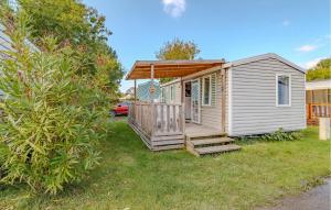 a tiny house with a porch and a deck at Stunning Stacaravan in Saint-Georges-de-Didonne