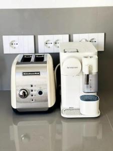 a counter with a coffee maker and a toaster at Zeus - Luxury Apartment in Como