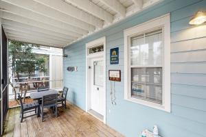 a front porch of a house with a table and chairs at Barefoot Cottages #B32 in Highland View