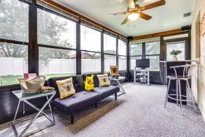 a living room with a couch and a ceiling fan at Orlando Vacation Rental with Yard and Pool Access in Orlando