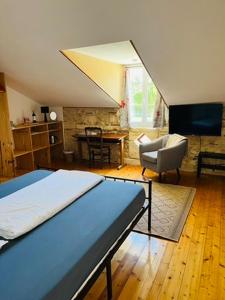 a bedroom with a bed and a living room at Maison Aubergerac in Bergerac
