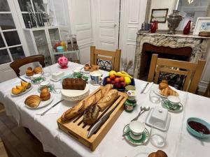 a table with bread and other food on it at Les Portes Bleues in Ay