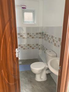 a bathroom with a toilet and a sink at Olive Homes Stylish 3 Bdrm Suites - 07 in Nakuru +14 photos