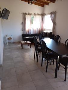 a living room with a table and chairs and a couch at Los Poin 2 in Mar de Cobo