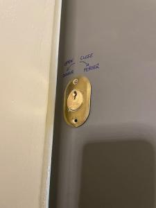 a metal door knob with a note on a wall at Studio cosy - 2 pers - Béziers - Centre - Terrasse - Clim in Béziers +18 photos