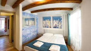 a bedroom with a large bed with two pillows on it at Piazza Grande City Residence in Trieste