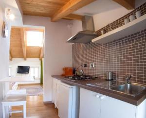 a kitchen with a sink and a counter top at Piazza Grande City Residence in Trieste