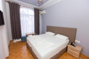 Postel nebo postele na pokoji v ubytování Hotel Triada
