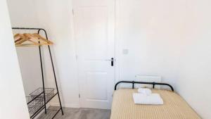 a bedroom with a bed and a white door at Host & Stay - Polwell Road in Kibworth Harcourt