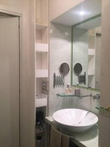 a bathroom with a white sink and a mirror at La dogana in Siena +22 photos