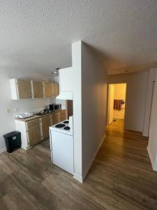 an empty kitchen with a white stove top oven at Close to TRU, Sun Peak, shopping in Kamloops