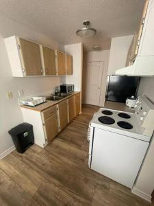 a kitchen with a stove and a white stove top oven at Close to TRU, Sun Peak, shopping in Kamloops
