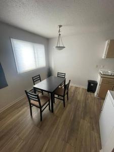 a dining room with a table and chairs in a kitchen at Close to TRU, Sun Peak, shopping in Kamloops
