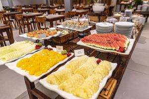 a buffet of different types of food on tables at Hotel Saint George in Puerto Iguazú