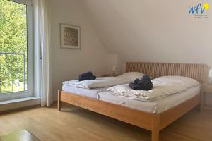 a bedroom with a bed with two pillows on it at Huus 24 in Borkum