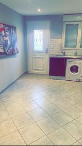 a laundry room with a door and a washing machine at Maison de charme Saint euphémie 2 in Sainte-Euphémie +6 photos