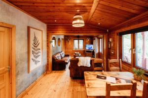 a living room with a couch and a table at Floral Lodge Great Ayton Yorkshire in Great Ayton
