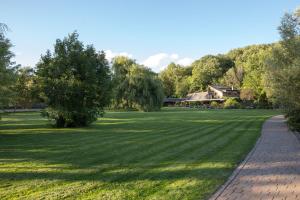 a large grass field with a house in the background at Floral Lodge Great Ayton Yorkshire in Great Ayton