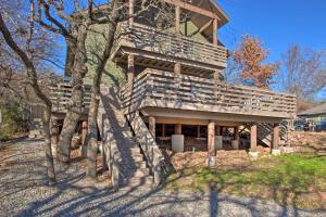 a large wooden house with a slide in front of it at Medicine Park Cabin with Mountain Views! in Medicine Park