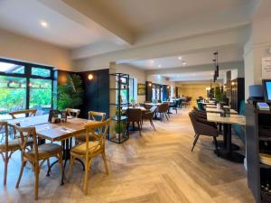 a restaurant with wooden tables and chairs and windows at Sky Lodge Great Ayton Yorkshire in Great Ayton