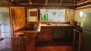 a kitchen with a counter and a sink and a window at Haliksai - Bungalows, Glamping and Retreatcenter in Las Lomas +60 photos