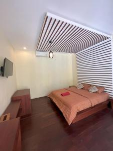 a bedroom with a large bed with a large window at Riverside Villa Tanah Lot by Smart Digital in Munggu +8 photos