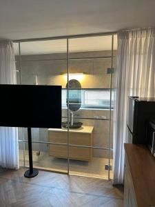 a living room with a television and a window at The new studio Florentin 4 in Tel Aviv +3 photos