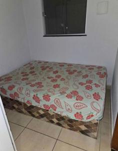una cama en una esquina de una habitación en casa de temporada, en Goiânia