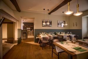 a restaurant with tables and chairs and a bar at Cà Nani Small Boutique Hotel in Casima