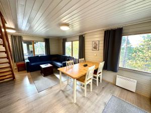 a living room with a table and a couch at Hillside Cottage in Ivalo +15 photos